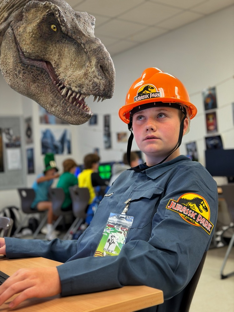 A student in class with a T-Rex looms over.