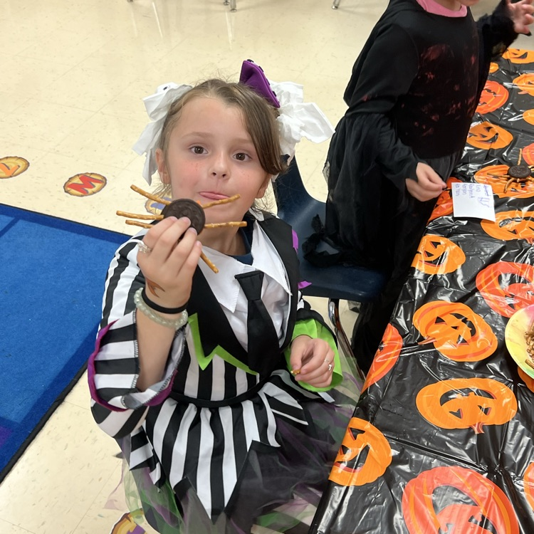 kindergarten students completing Halloween academic activities