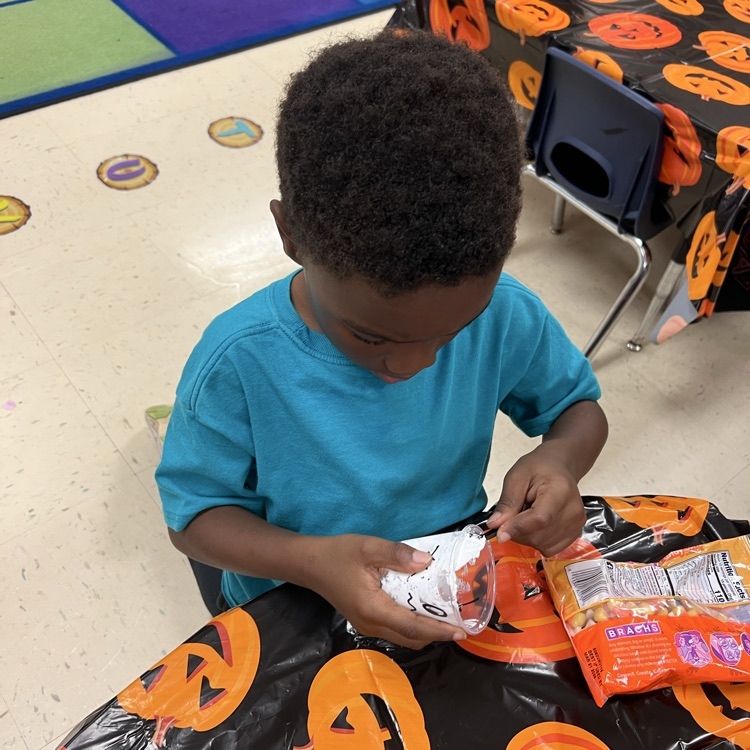 kindergarten students completing Halloween academic activities