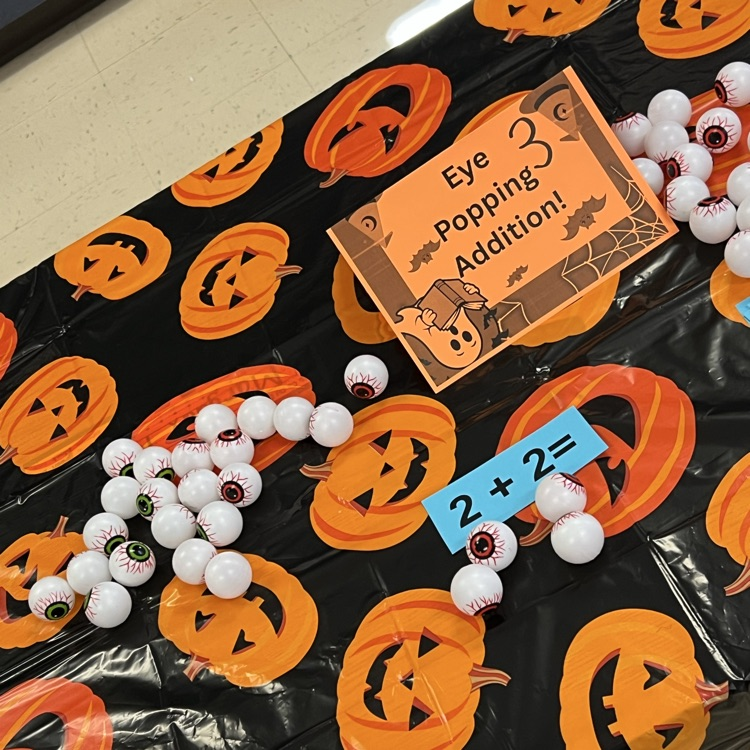 kindergarten students completing Halloween academic activities