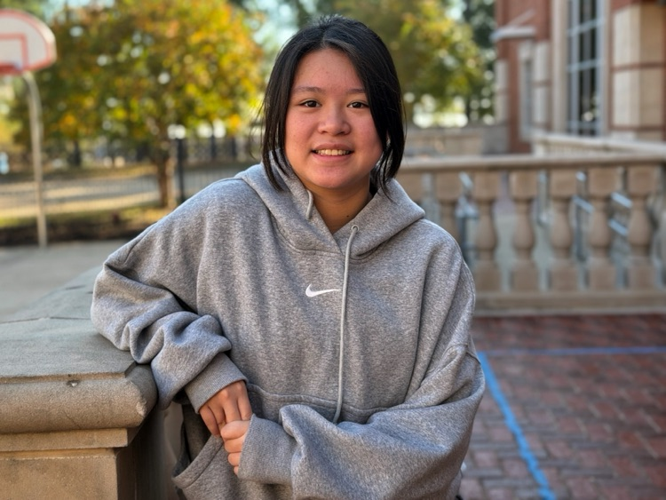 A student standing in the courtyard.