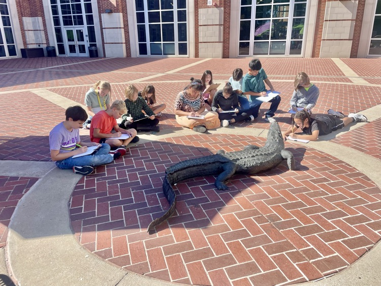 Students drawing in the courtyard.