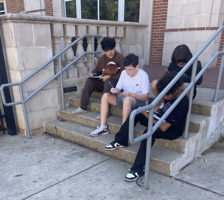 Students drawing in the courtyard.