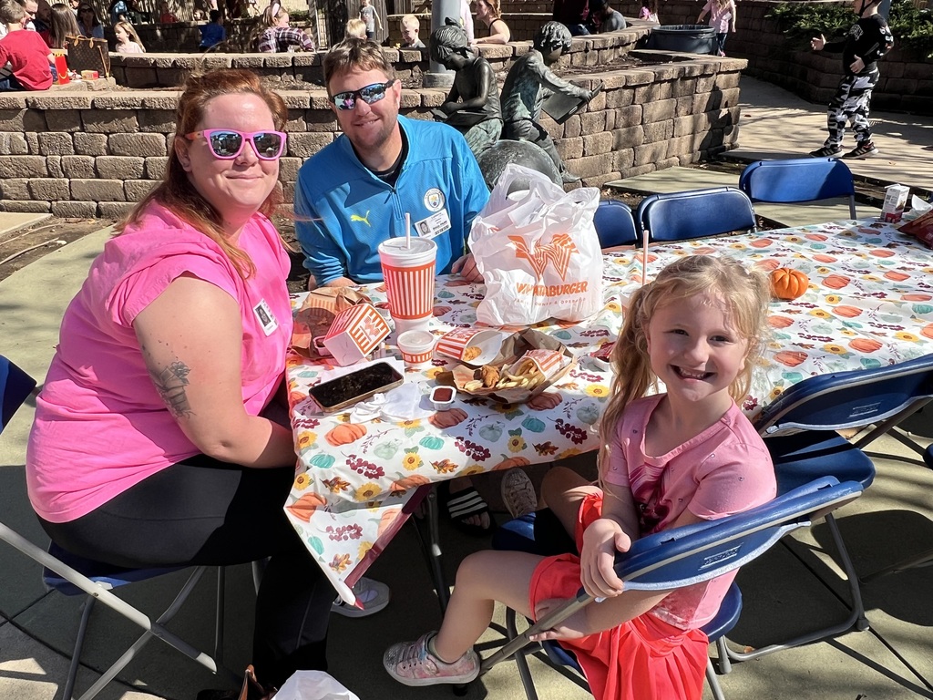 Parents eating with their student