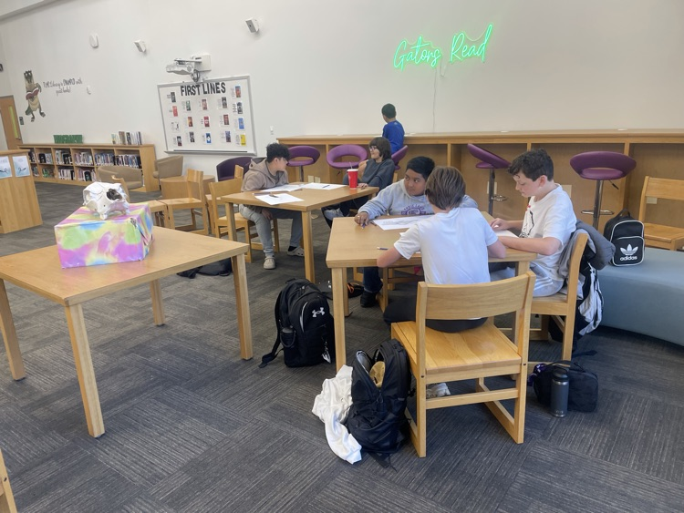 Students drawing in the library.