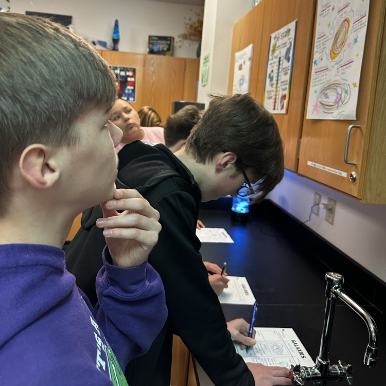 students making posters over galaxies