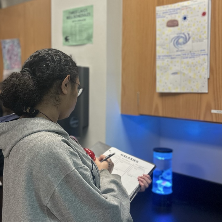 students making posters over galaxies