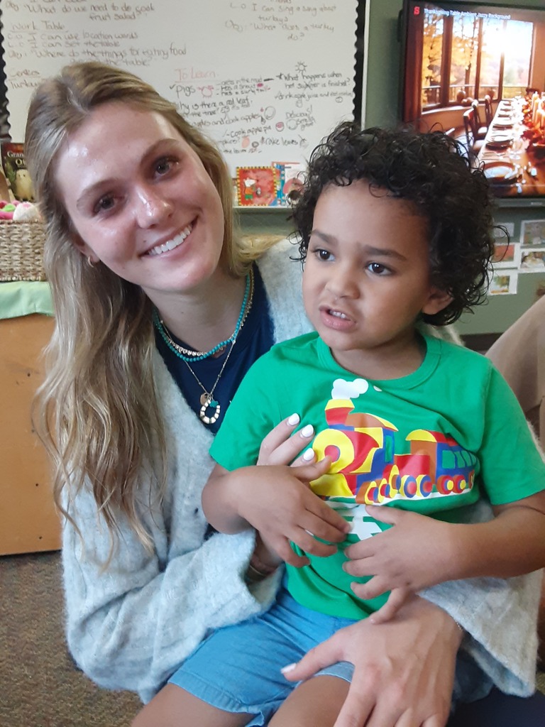 High school student and preschool student sitting together