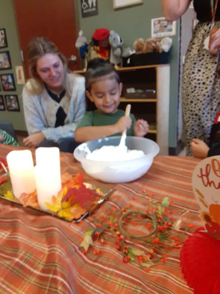 High school student and preschool student cooking together