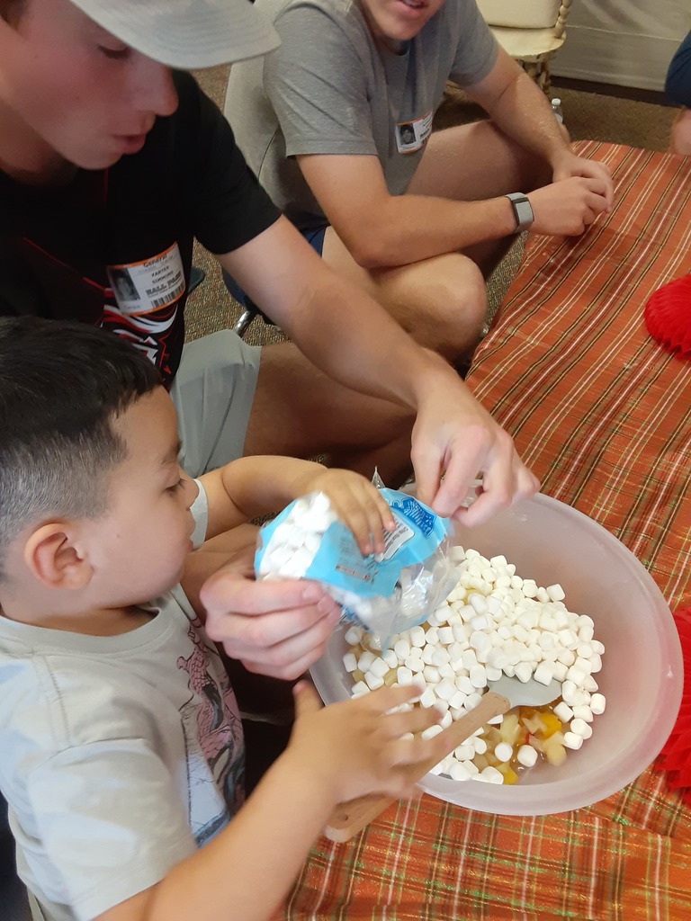High school student and preschool student cooking together