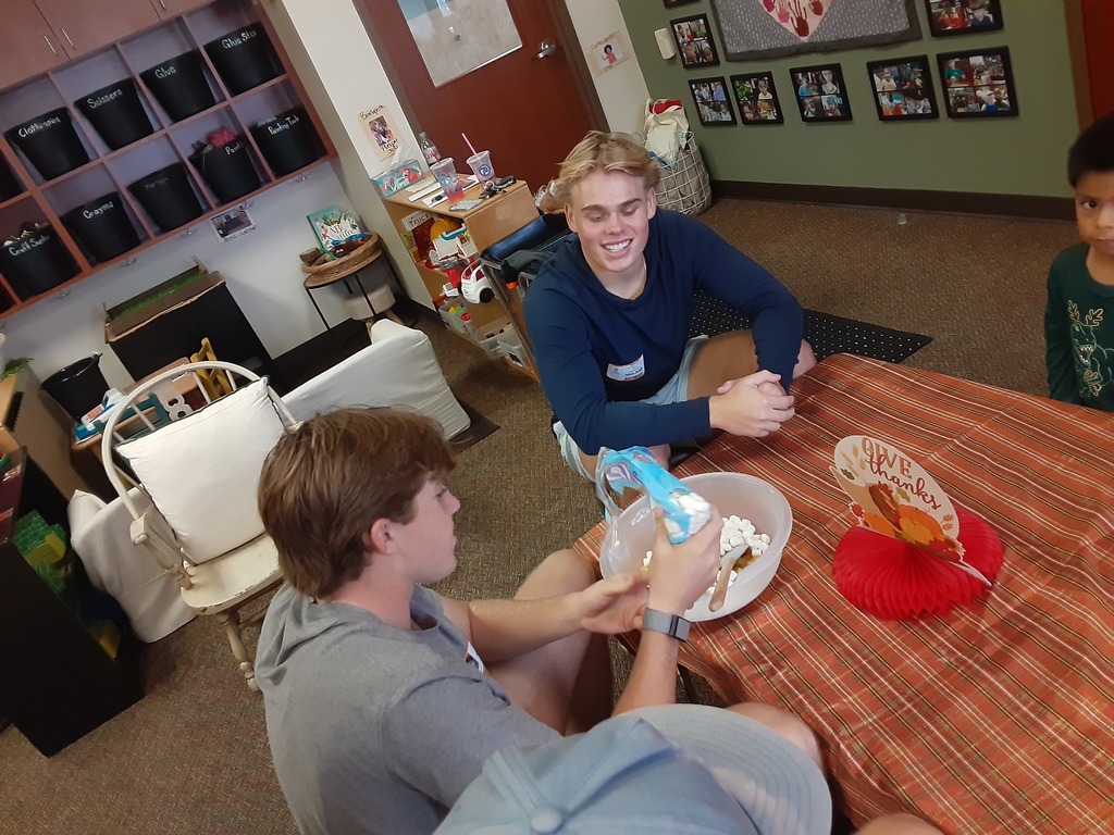 High School and preschool students cooking together