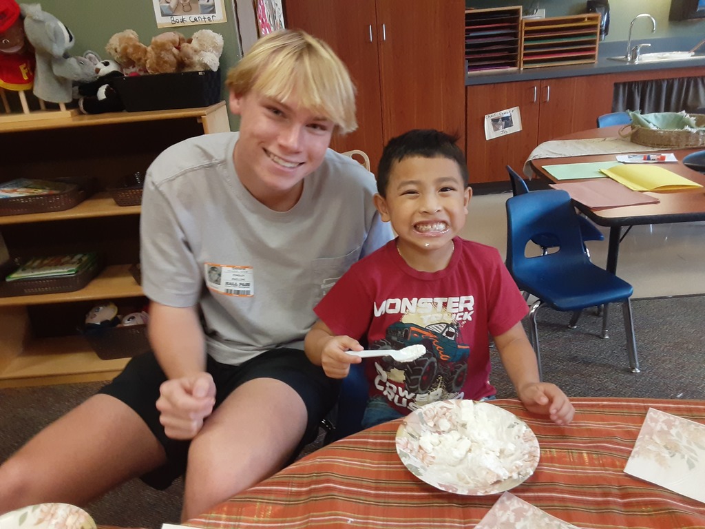 High school student and preschool student eating together