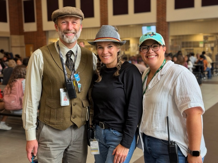 The three assistant principals standing in the cafeteria.