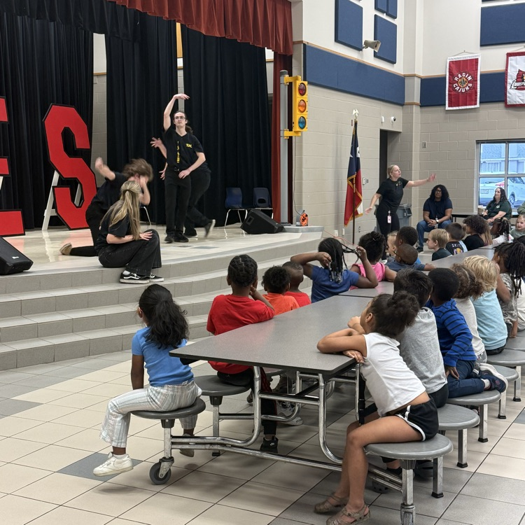 students watching a fairy tale play on stage in the cafe