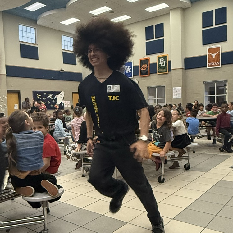 students watching a fairy tale play on stage in the cafe