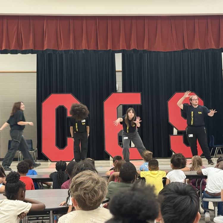 students watching a fairy tale play on stage in the cafe