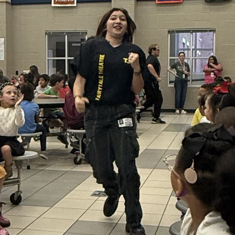 students watching a fairy tale play on stage in the cafe