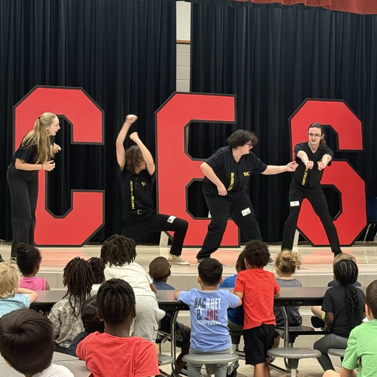 students watching a fairy tale play on stage in the cafe