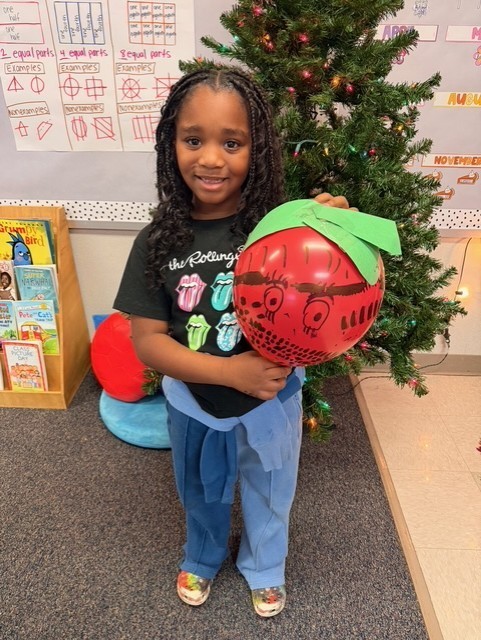 Student holding decorated balloons