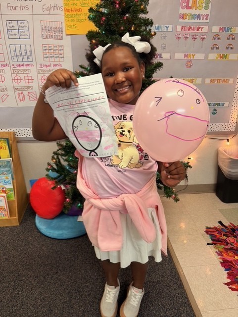 Student holding decorated balloons
