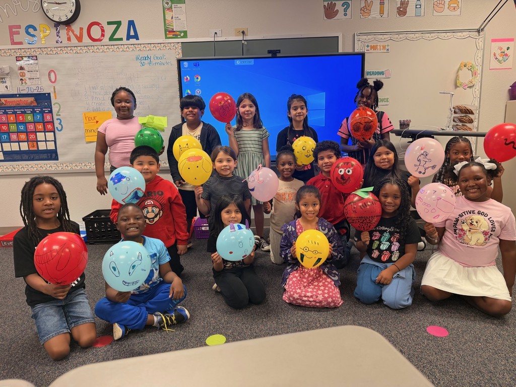 Students holding decorated balloons
