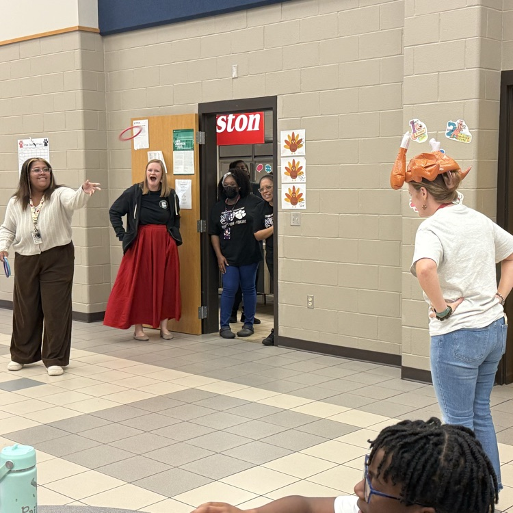 teachers throwing rings at woman’s turkey hat