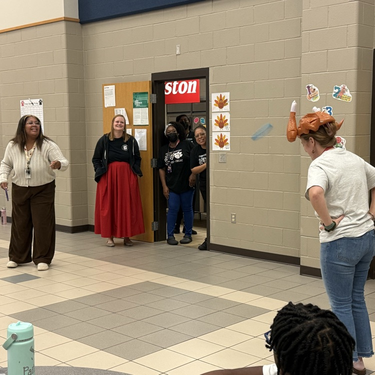 teachers throwing rings at woman’s turkey hat