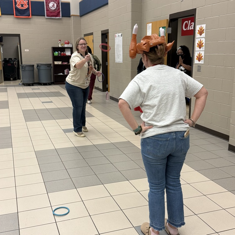 teachers throwing rings at woman’s turkey hat