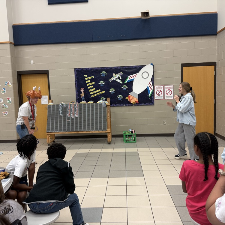 teachers throwing rings at woman’s turkey hat
