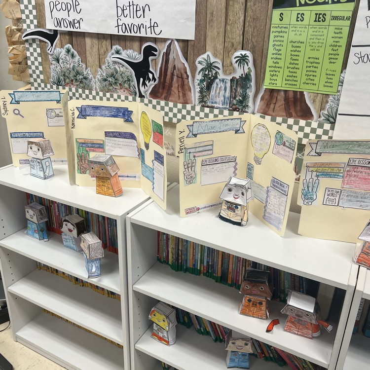 students posing with their bobblehead astronauts and file folder biographies 