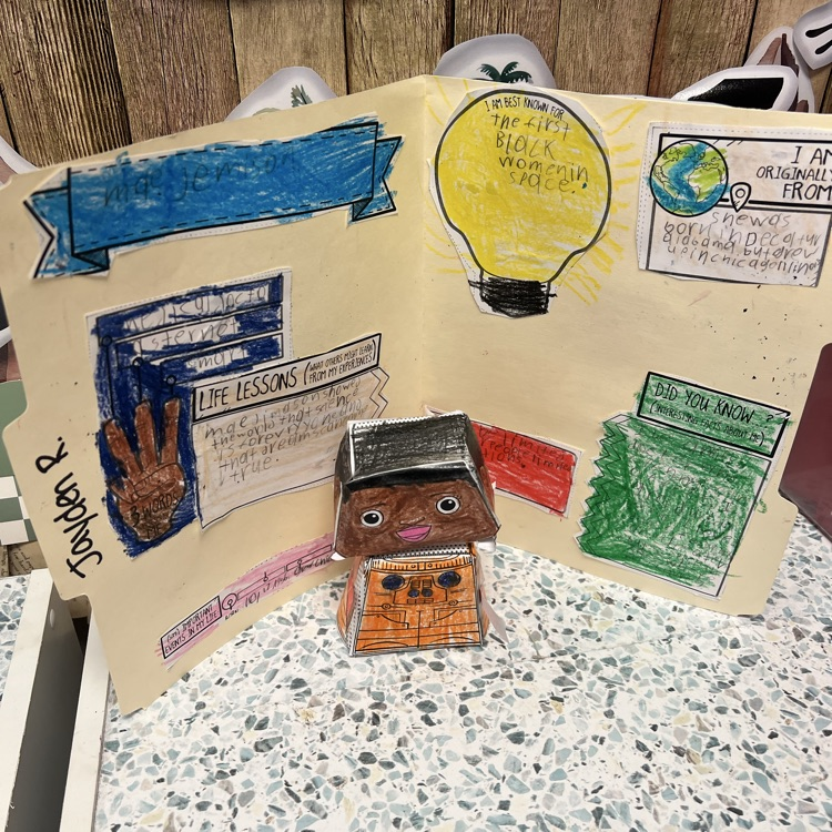 students posing with their bobblehead astronauts and file folder biographies 