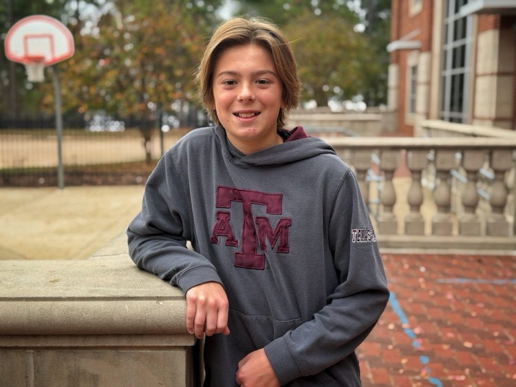 A student standing in the courtyard.