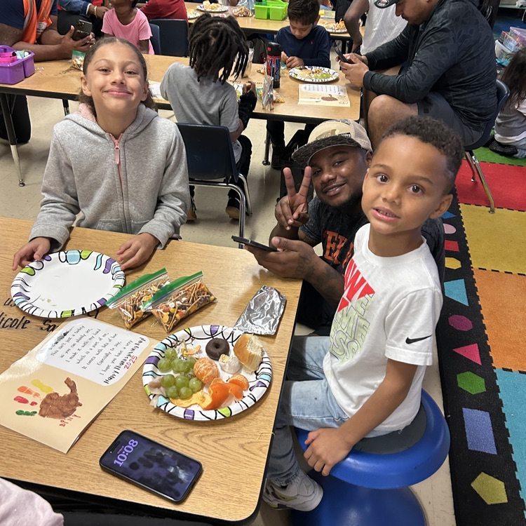 family smiling during Thanksgiving feast 