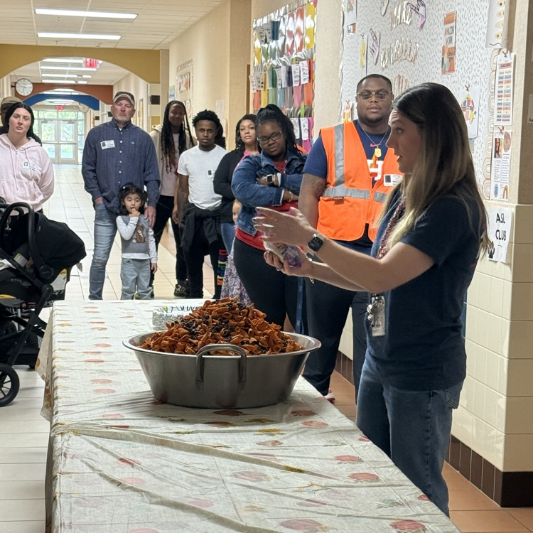 teacher showing how to create Thanksgiving trail mix 