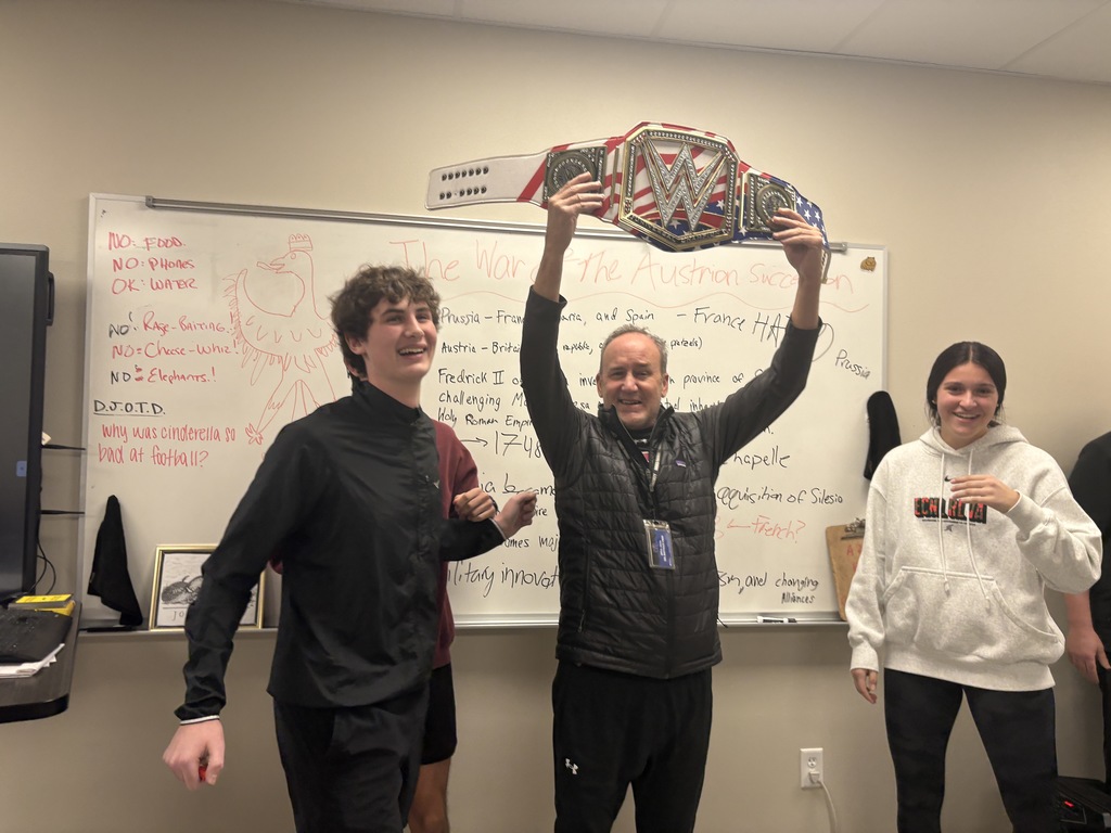 Coach Hesskew with his students and the Walk Through Wednesday belt