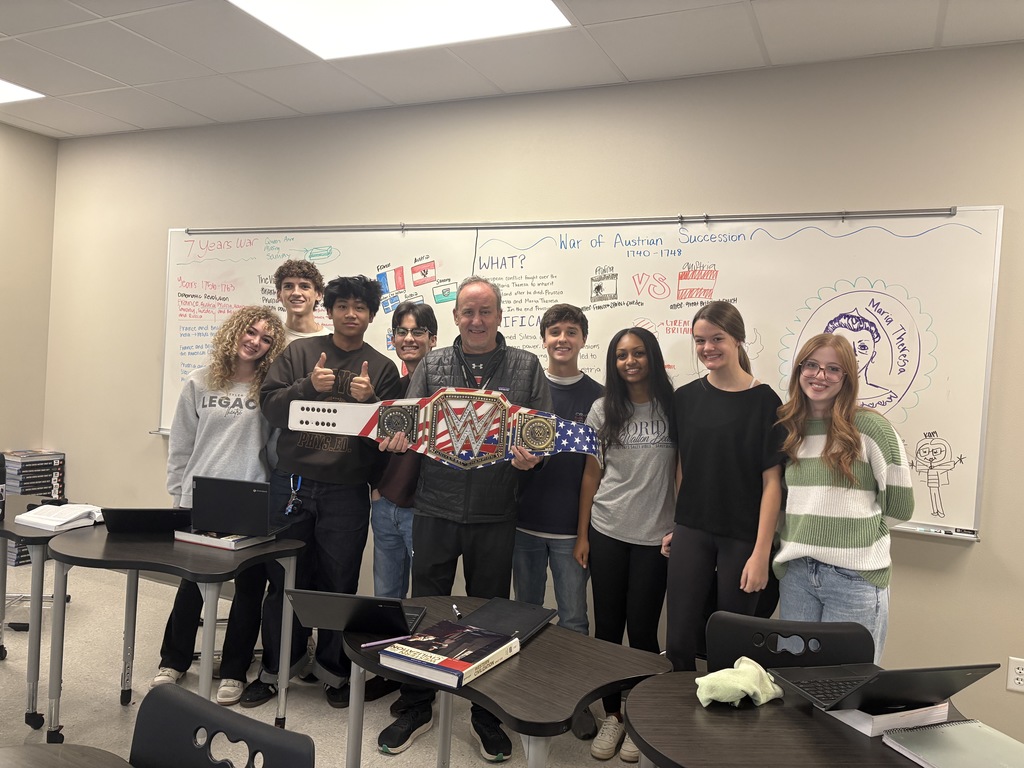 Coach Hesskew with his students and the Walk Through Wednesday belt