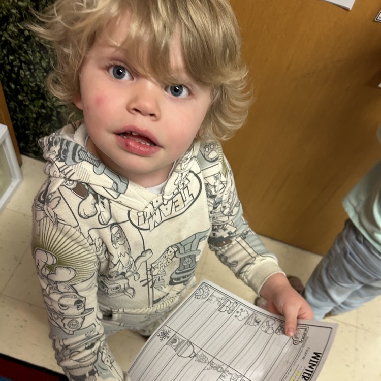 Pre-K student riding winter words around the room