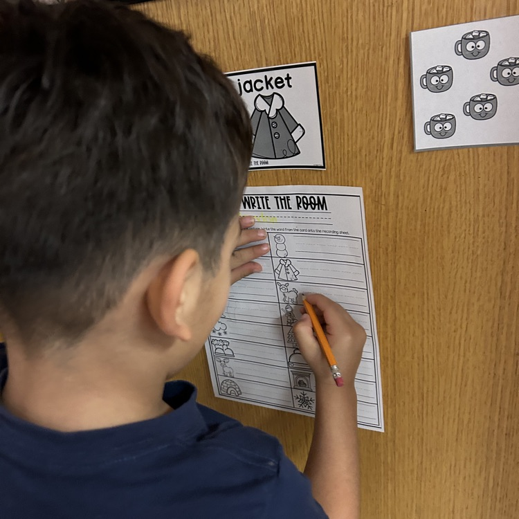 Pre-K student riding winter words around the room