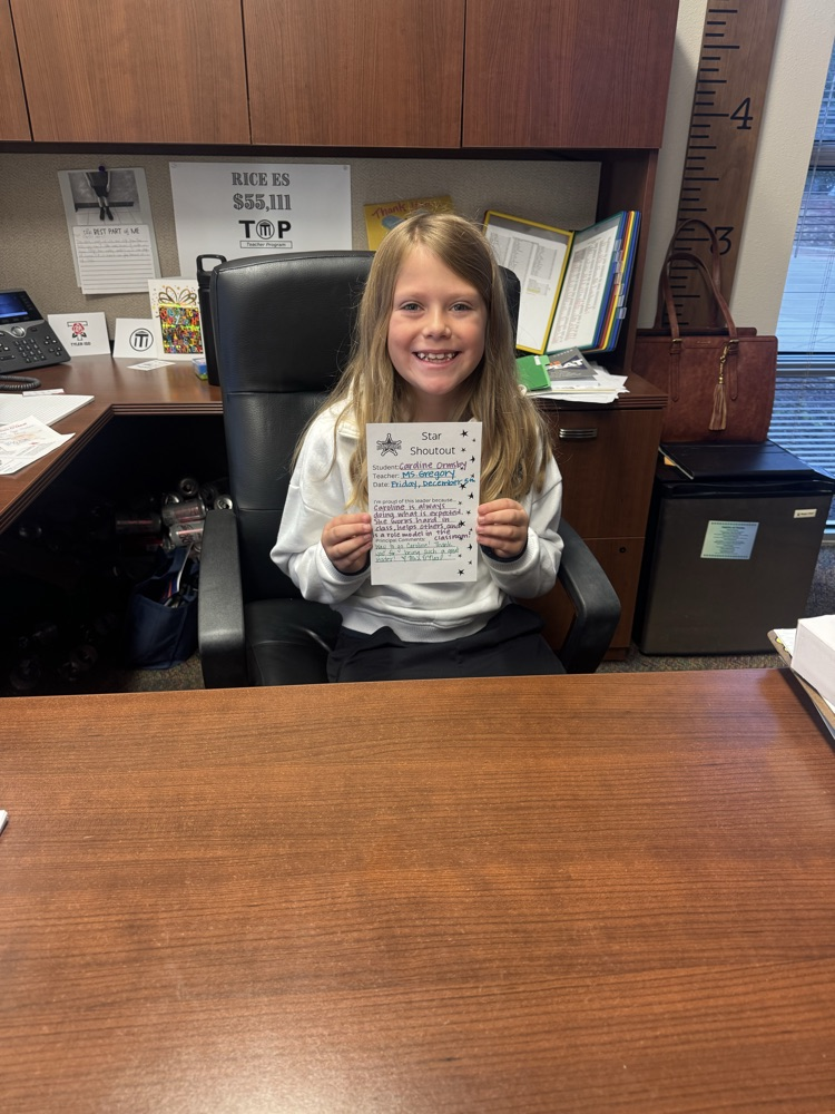 student sitting at the principals desk