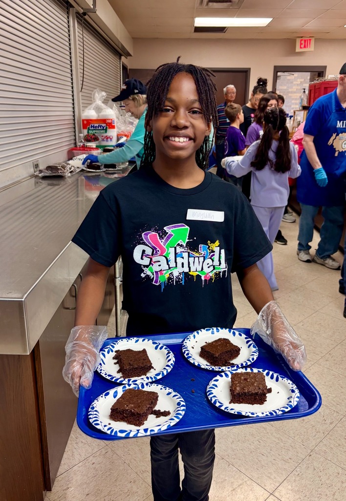 Caldwell student smiles as she serves brownies at the service project.