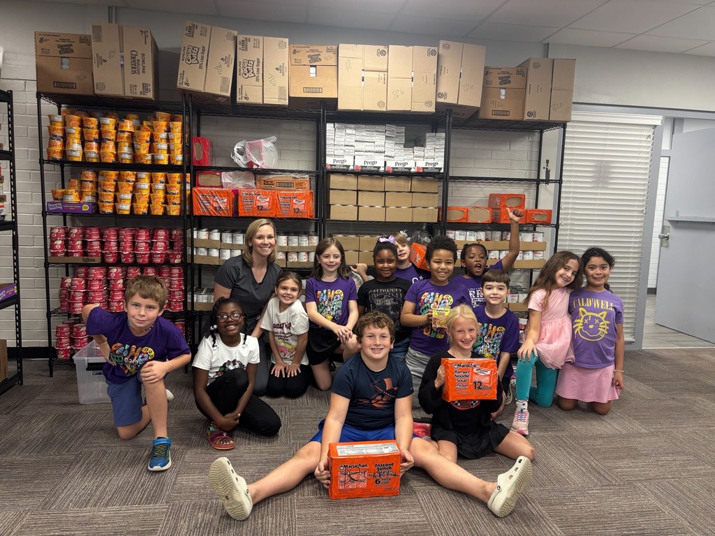 Group of Caldwell students smile as they help contribute to a food pantry.