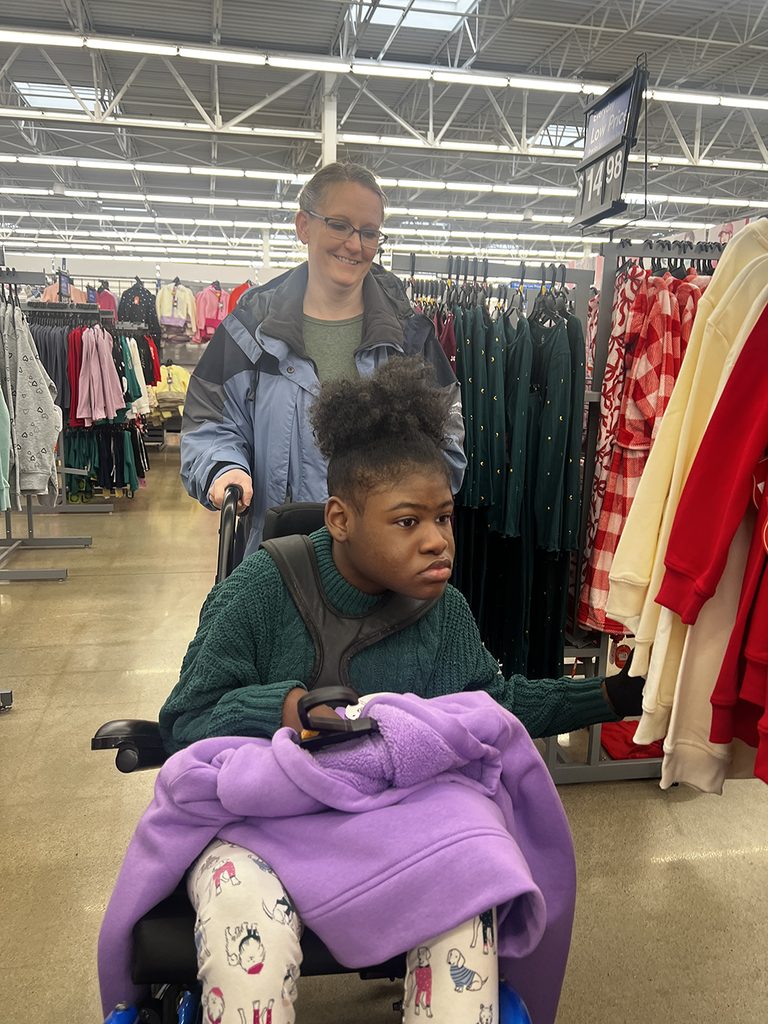 Boshears student is wheeled through clothing isles during this yearβs Mostyn Moreno Foundation Christmas Lights shopping excursion.