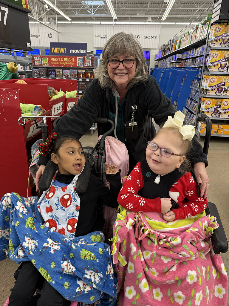 Two Boshears students and teacher smile during this yearβs Mostyn Moreno Foundation Christmas Lights shopping excursion.