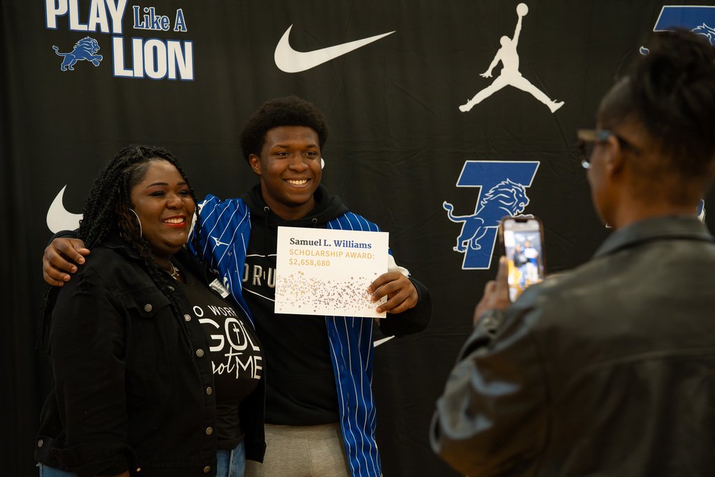 Tyler High Student smiles with parent at the UV Scholarship celebration.