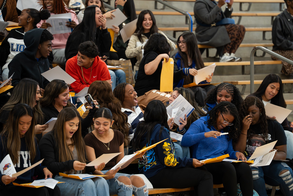 Tyler High seniors scream with excitement as the UV Scholarship opportunities are revealed.