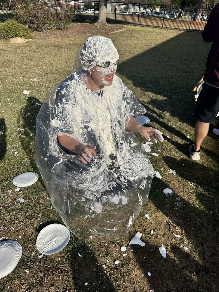 students throwing pies at Mrs. Harville