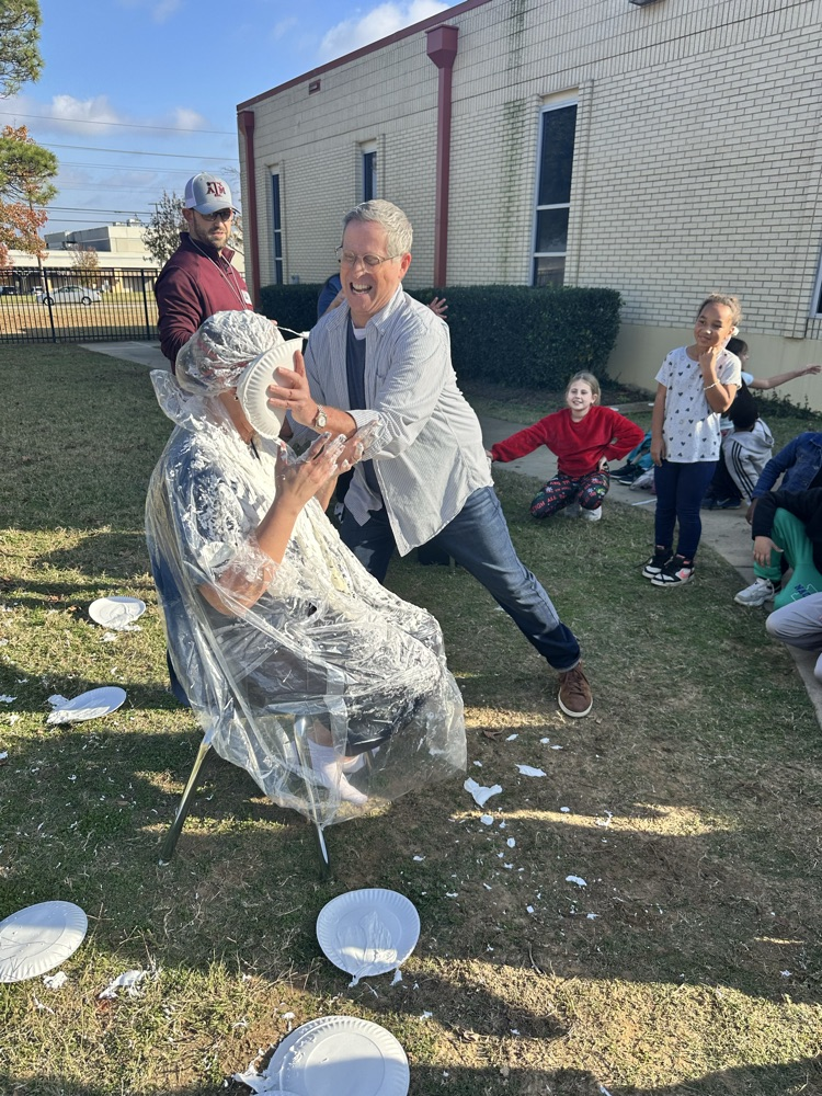 students throwing pies at Mrs. Harville
