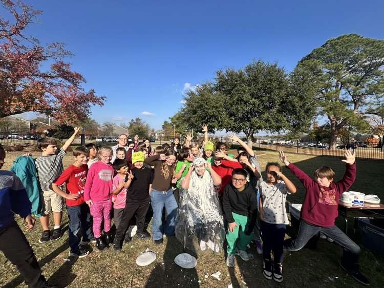 students throwing pies at Mrs. Harville