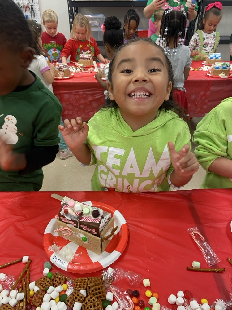 Kids making gingerbread houses.
