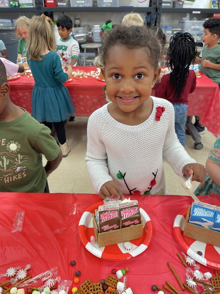 Kids making gingerbread houses.
